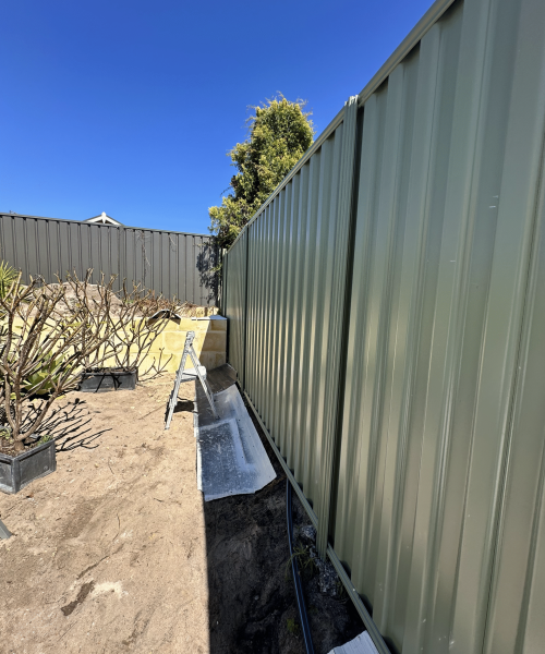 Painter applying smooth finish on interior walls in Perth home